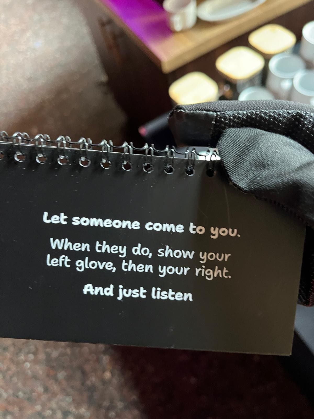 A card in the booklet reading: Let someone come to you. When they do, show your left glove, then your right. And just listen