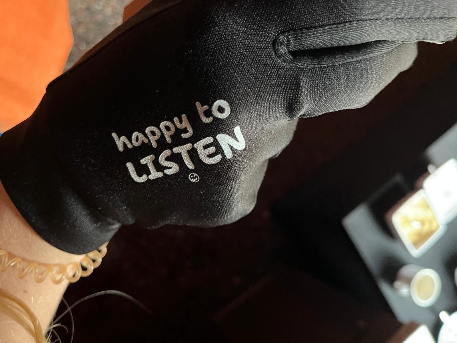 The right glove, printed with: happy to LISTEN, with a smiley